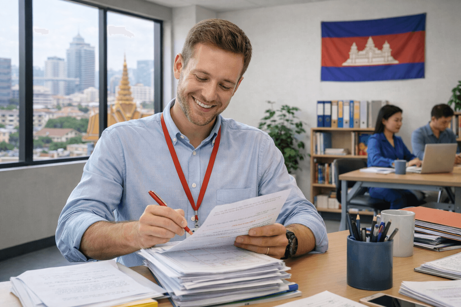 A teacher marking papers in a classroom in Phnom Penh, Cambodia