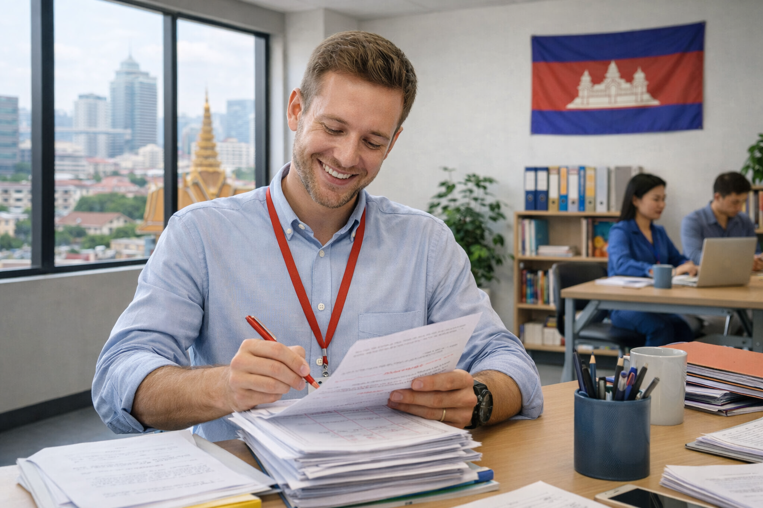 Teacher marking papers — preparing TEFL coursework for English students in Cambodia